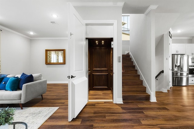 staircase featuring ornamental molding and hardwood / wood-style floors