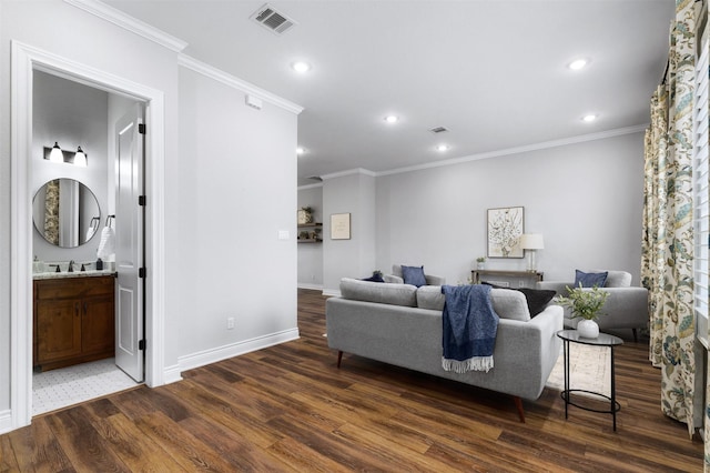 living room featuring dark wood-type flooring, sink, and ornamental molding