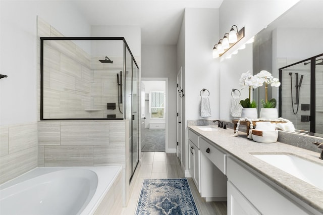 bathroom featuring separate shower and tub and vanity