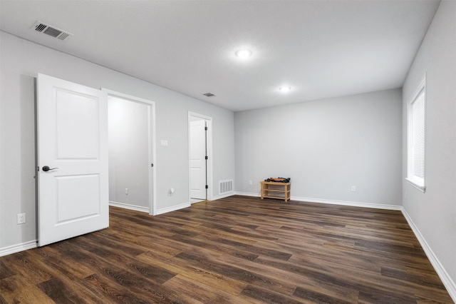 spare room with dark hardwood / wood-style flooring