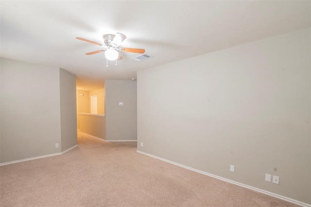 spare room with light colored carpet and ceiling fan