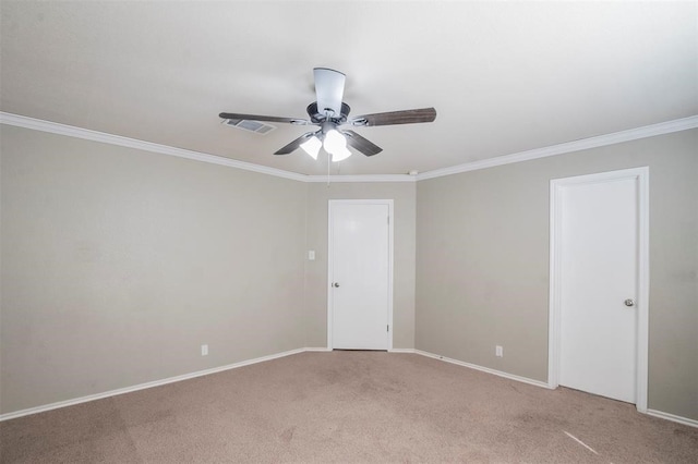 carpeted empty room with ceiling fan and crown molding