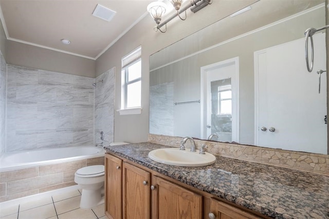 full bathroom featuring vanity, tile patterned floors, tiled shower / bath, crown molding, and toilet