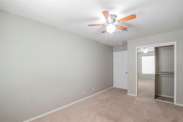 unfurnished bedroom featuring light carpet, a closet, and ceiling fan