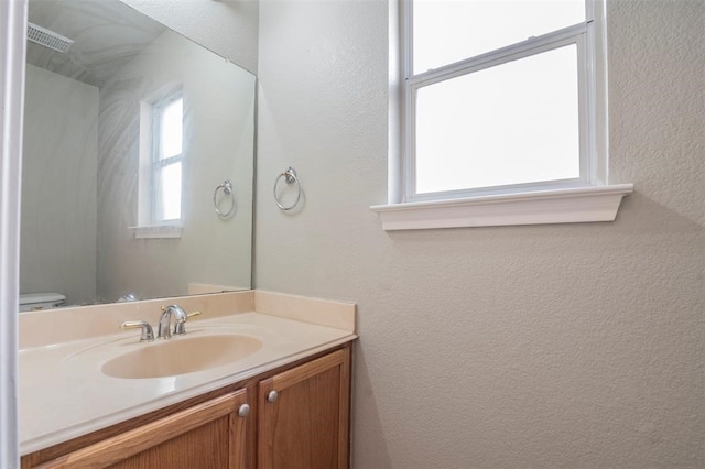 bathroom with vanity and toilet