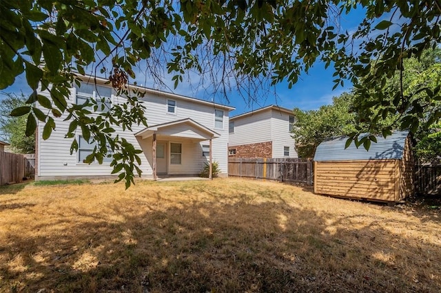 back of property featuring a lawn