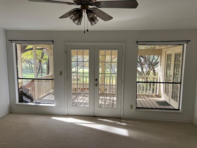 doorway featuring carpet, ceiling fan, and french doors