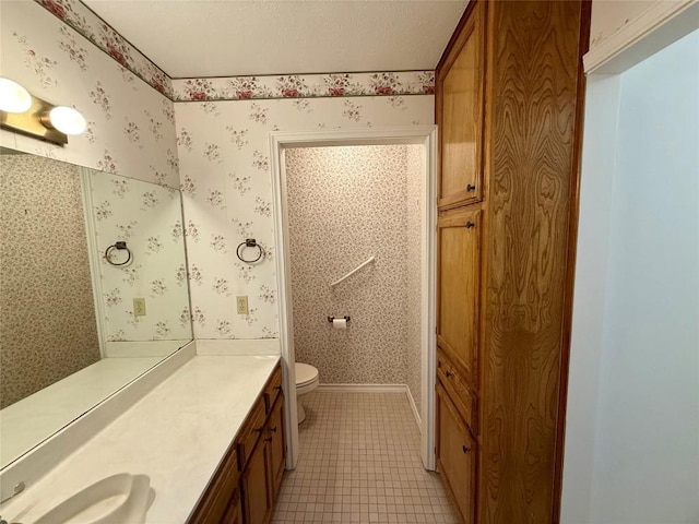 bathroom featuring tile patterned flooring, vanity, and toilet