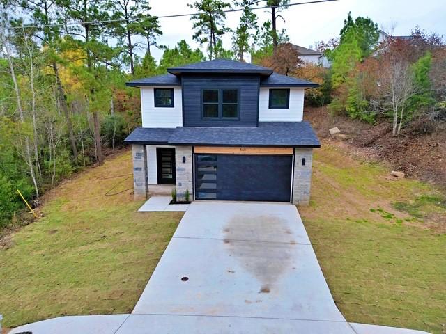 view of front of house with a front yard and a garage