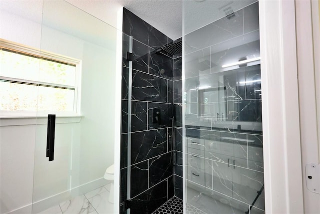 bathroom featuring a textured ceiling, an enclosed shower, and toilet