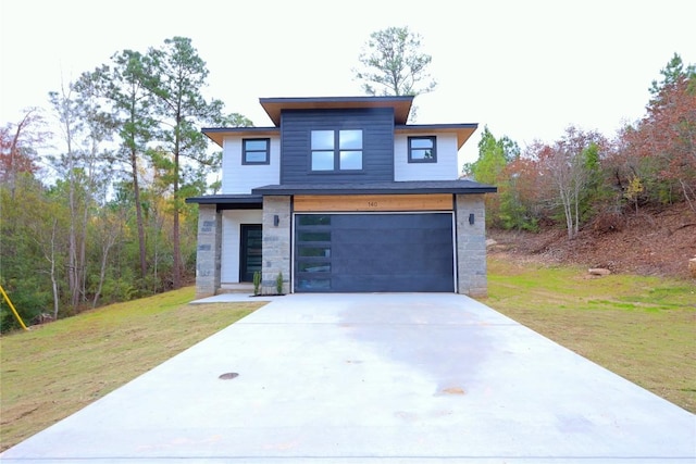 modern home featuring a garage and a front yard