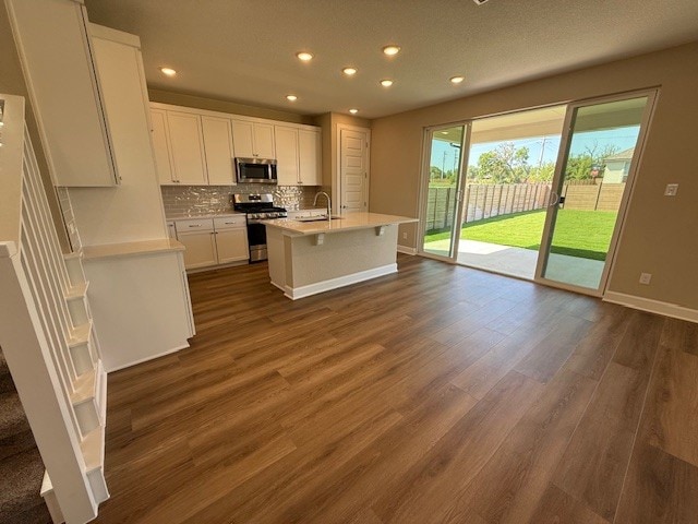 132 Alistair Dr, Georgetown, TX 78633 - kitchen featuring stainless steel appliances, decorative backsplash, light countertops, recessed lighting, and white cabinets