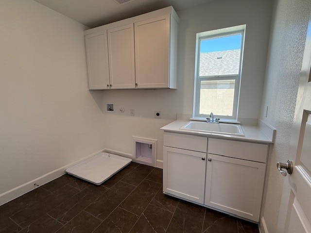 132 Alistair Dr, Georgetown, TX 78633 - laundry area with electric dryer hookup, hookup for a washing machine, cabinet space, gas dryer hookup, and baseboards