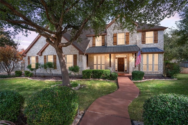 504 River Down Rd, Georgetown, TX 78628 - view of front of property with stone siding, a front yard, and a standing seam roof