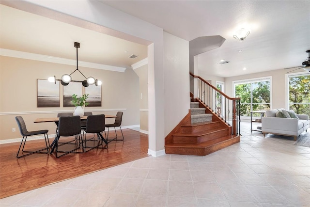 504 River Down Rd, Georgetown, TX 78628 - dining room featuring a chandelier, stairway, ornamental molding, and light tile patterned floors