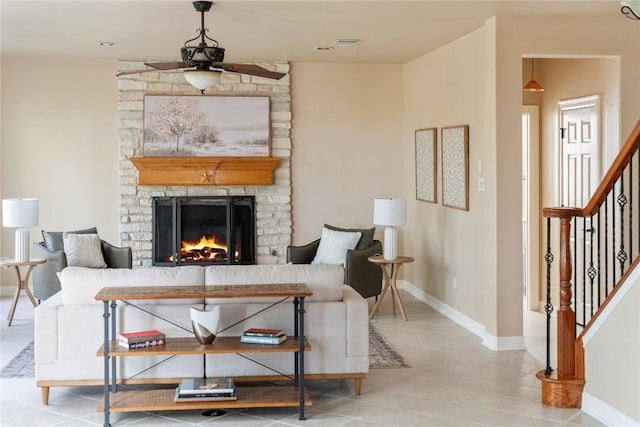 504 River Down Rd, Georgetown, TX 78628 - tiled living room with a ceiling fan, stairway, and a stone fireplace