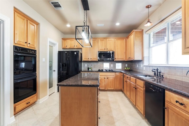 504 River Down Rd, Georgetown, TX 78628 - kitchen with black appliances, a kitchen island, dark stone counters, backsplash, and light brown cabinetry