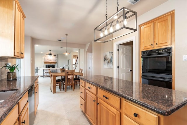 kitchen featuring dishwasher, dark stone countertops, black double oven, decorative light fixtures, and a kitchen island