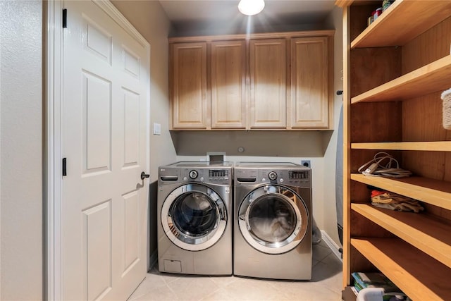 504 River Down Rd, Georgetown, TX 78628 - washroom featuring cabinet space, washer and clothes dryer, and light tile patterned flooring