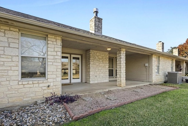 rear view of property featuring central AC