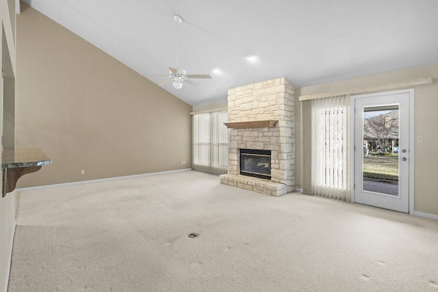 unfurnished living room featuring ceiling fan, a stone fireplace, carpet floors, and high vaulted ceiling