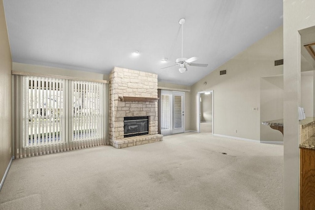 unfurnished living room featuring ceiling fan, a stone fireplace, light carpet, and high vaulted ceiling