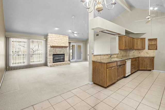 kitchen with a stone fireplace, beamed ceiling, high vaulted ceiling, white dishwasher, and light colored carpet