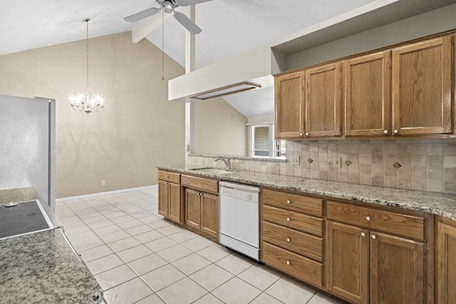 kitchen with dishwasher, sink, decorative backsplash, decorative light fixtures, and stainless steel refrigerator