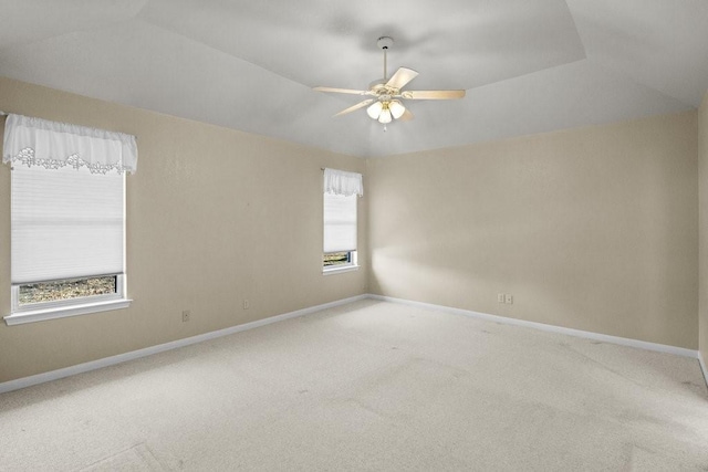 unfurnished room featuring carpet flooring, ceiling fan, a raised ceiling, and lofted ceiling