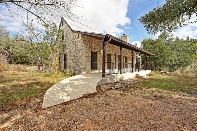 13000 Grubstake Gulch St, Bee Cave, TX 78738 - rear view of house featuring stone siding and a chimney