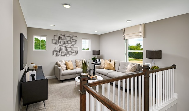 carpeted living room featuring plenty of natural light