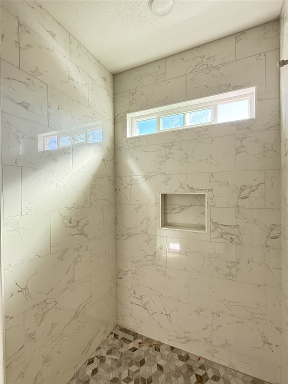 247 Fawn Ridge Dr, Copperas Cove, TX 76522 - bathroom featuring tiled shower and a textured ceiling