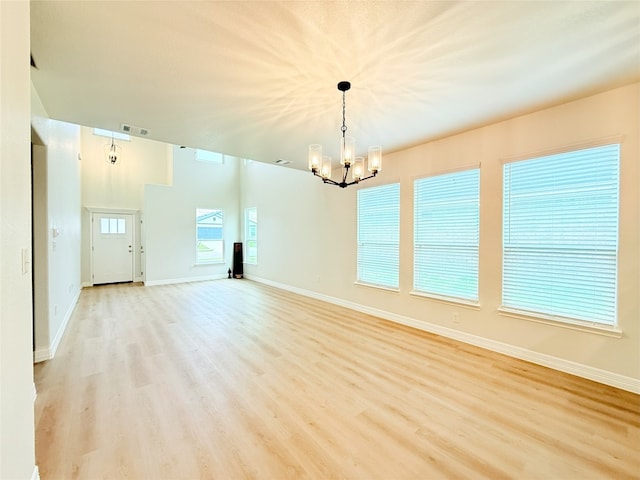 247 Fawn Ridge Dr, Copperas Cove, TX 76522 - spare room with a chandelier, light wood finished floors, and baseboards