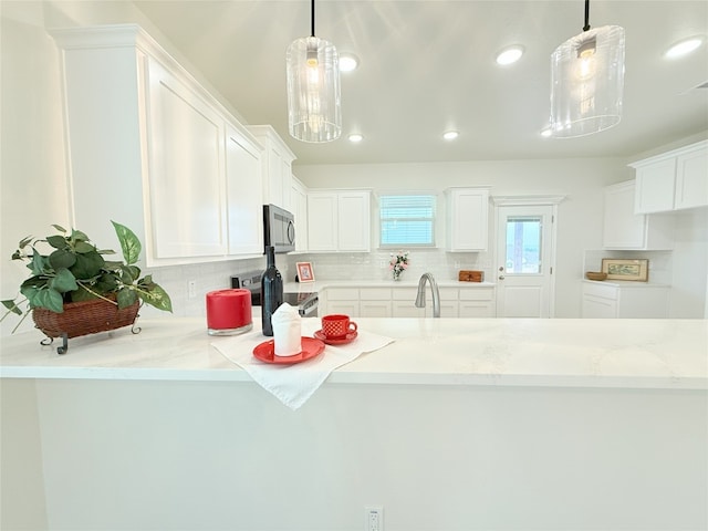 247 Fawn Ridge Dr, Copperas Cove, TX 76522 - kitchen with range, stainless steel microwave, decorative backsplash, white cabinets, and recessed lighting