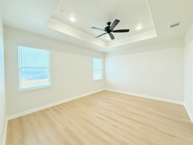 247 Fawn Ridge Dr, Copperas Cove, TX 76522 - spare room featuring a tray ceiling, crown molding, light wood-style floors, baseboards, and ceiling fan