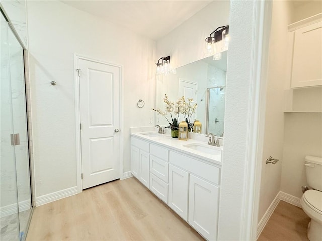 247 Fawn Ridge Dr, Copperas Cove, TX 76522 - full bath with toilet, a shower stall, double vanity, wood finished floors, and baseboards