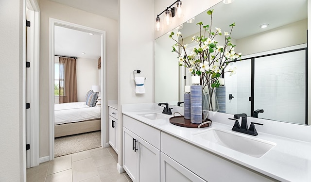 bathroom with tile patterned flooring, vanity, and a shower with shower door