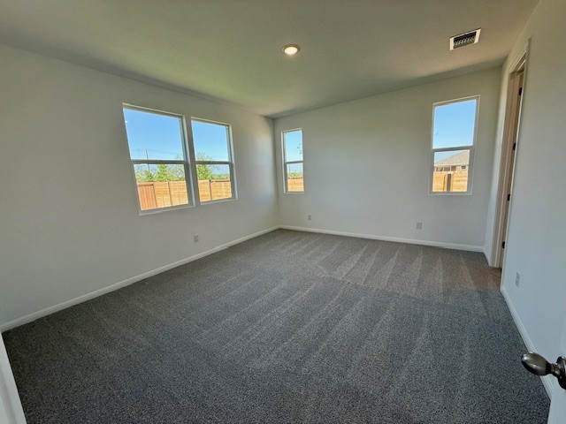 1020 Stonehill Dr, Georgetown, TX 78633 - unfurnished room with dark carpet, baseboards, and recessed lighting