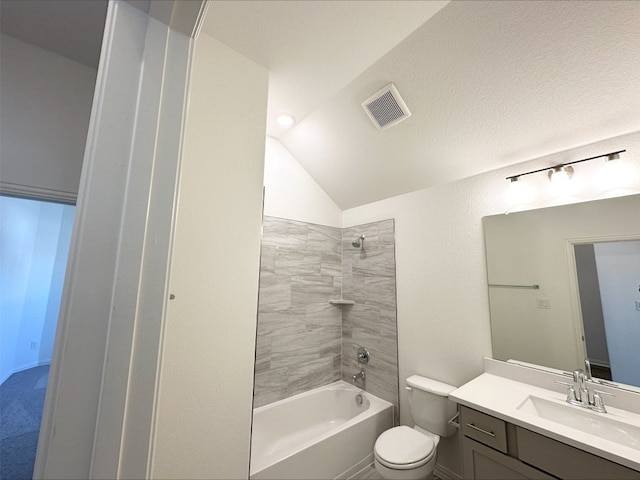 bathroom with lofted ceiling, toilet, vanity, visible vents, and shower / washtub combination