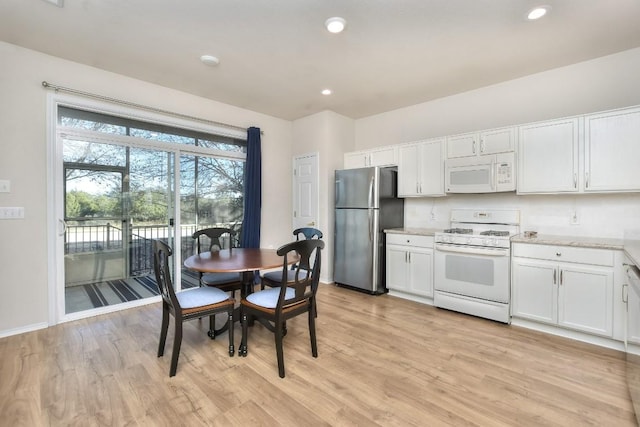 kitchen featuring recessed lighting, light wood-style floors, white cabinets, white appliances, and baseboards