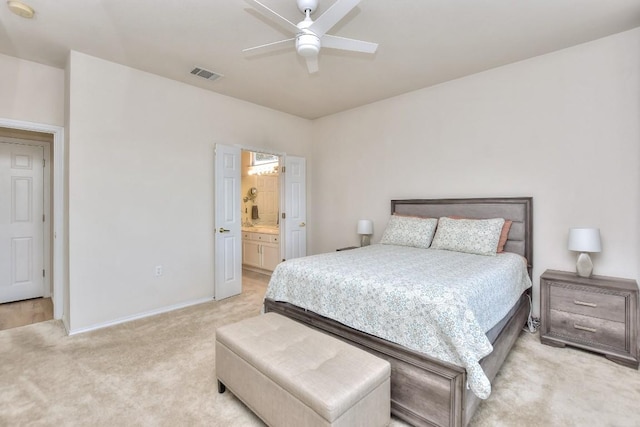 bedroom with ceiling fan, connected bathroom, light colored carpet, visible vents, and baseboards