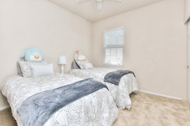 bedroom with baseboards, a ceiling fan, and light colored carpet