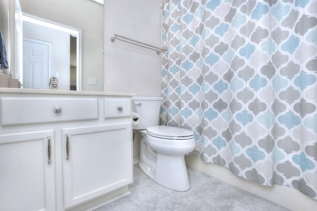 full bath featuring toilet, a shower with shower curtain, and vanity