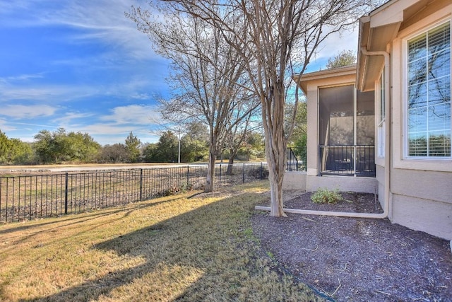 view of yard featuring a fenced backyard and a sunroom