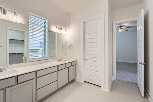 144 Adelton Blvd, Bastrop, TX 78602 - bathroom with double vanity, a ceiling fan, tile patterned floors, and baseboards