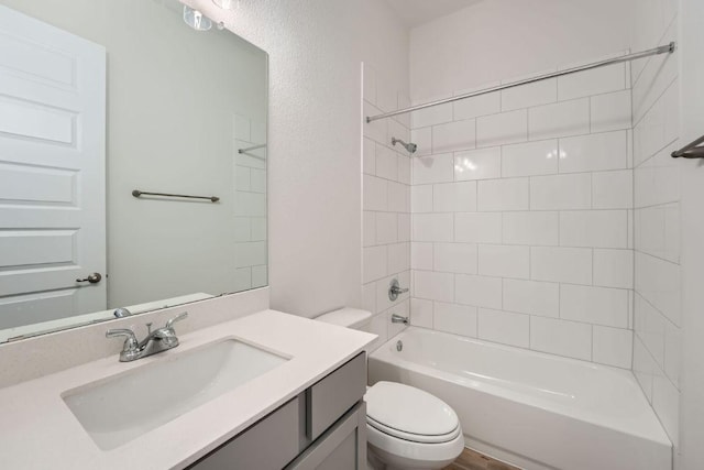 bathroom featuring toilet, vanity, and bathing tub / shower combination