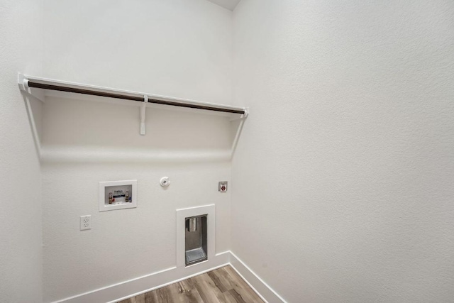 laundry room featuring gas dryer hookup, hookup for a washing machine, baseboards, wood finished floors, and laundry area