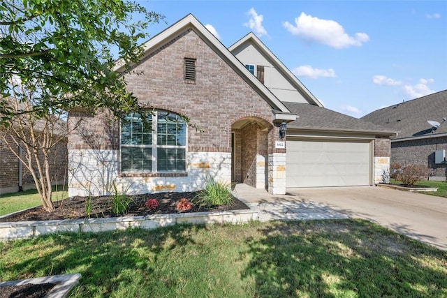 view of front of home with a front yard and a garage