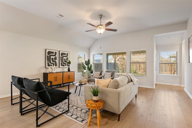 living room featuring ceiling fan, vaulted ceiling, and light wood-type flooring