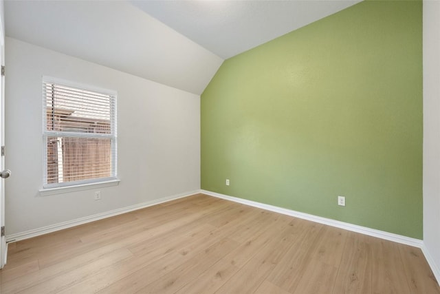 unfurnished room featuring light hardwood / wood-style flooring and lofted ceiling